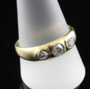 A gentleman`s 18ct gold and three stone gypsy set diamond ring, size W.