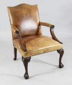 A George III style brown leather Gainsborough type chair, with brass studs, carved cabriole legs and