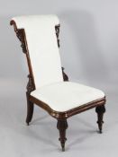 A large Victorian mahogany prie dieu, with upholstered scrolling back and acanthus carved corner