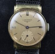 A gentleman`s 14ct gold mid-size Longines manual wind wrist watch, the golden dial with baton and