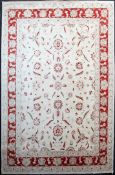 A Ziegler carpet, with field of geometric red and green foliate motifs on an ivory ground, with