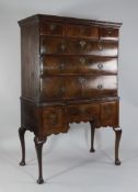 An 18th century walnut chest on stand, with three short drawers over three long drawers and a