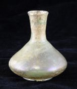 A Roman glass bottle vase, with a conical shaped body and mineral iridescence, 3.8in.