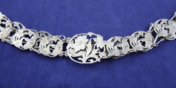 An Edwardian Art Nouveau silver belt, with nineteen pierced foliate circular links and pierced