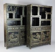 A pair of Chinese black lacquer side cabinets, decorated with gilt and polychrome floral motifs