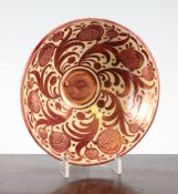 A Bushey Heath ruby lustre pottery bowl, c.1927, painted with stylised fruit and feathery leaves