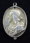 A Charles I silver gilt royalist badge, of oval form, cast with the bust of Charles I and