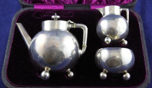 A cased stylish Victorian silver three piece bachelor`s tea set by Walter & John Barnard, of