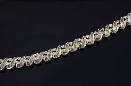 A yellow gold and diamond interwoven link bracelet, set with round and graduated baguette cut