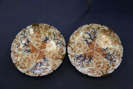 A pair of large Japanese Imari dishes, Meiji period, painted with alternating panels of flowers,