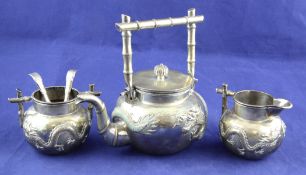 A late 19th/early 20th century matched Chinese silver three piece tea set, of globular form, with