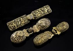 Three Chinese gilt bronze belt buckles, Qing dynasty, two cast and pierced with dragons amid clouds,