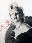 A frame and glazed signed photograph of Marilyn Monroe, inscribed "Warmest regards, Marilyn