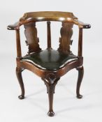 A George II mahogany library desk armchair, with horseshoe top rail, solid vase splats and drop in