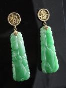 A pair of Chinese gold and jadeite drop earrings, of tapering form, carved with gourds, the pin with