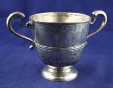 A George I Irish silver two-handled trophy cup, with engraved armorial and banded girdle, (repairs),