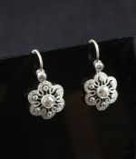 A pair of white and diamond cluster earrings, of pierced flowerhead design. 0.5in.