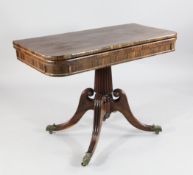 A Regency rosewood folding card table, with tapering fluted central column, four moulded downswept