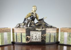 A French Art Deco three piece marble and onyx clock garniture, mounted with a painted brass figure