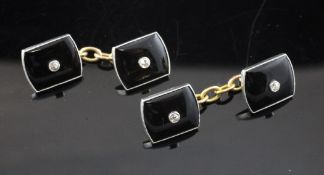 A pair of 18ct gold and platinum, black onyx and diamond cufflinks.