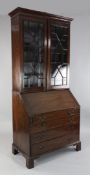 A George III mahogany bureau bookcase, with two astragal glazed doors over fall front with fitted