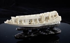 A Chinese ivory model of a boat, early 20th century, carved and pierced with figures on deck, 20.