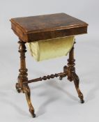 A Victorian walnut work table, with rising lid revealing a fitted interior, on turned pole