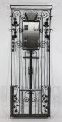 A French Art Deco wrought iron hall stand, with integral frosted glass shade, rectangular mirror