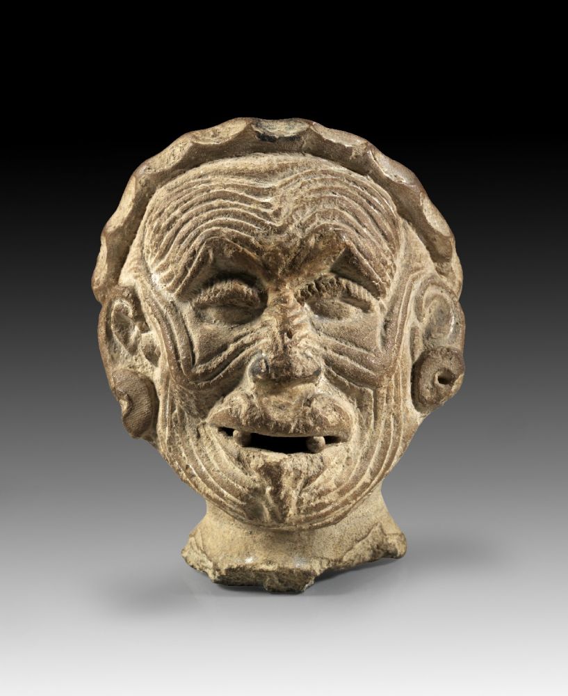 Hollow terracotta head of an old, teethless man with deep wrinkles and large earrings, probably