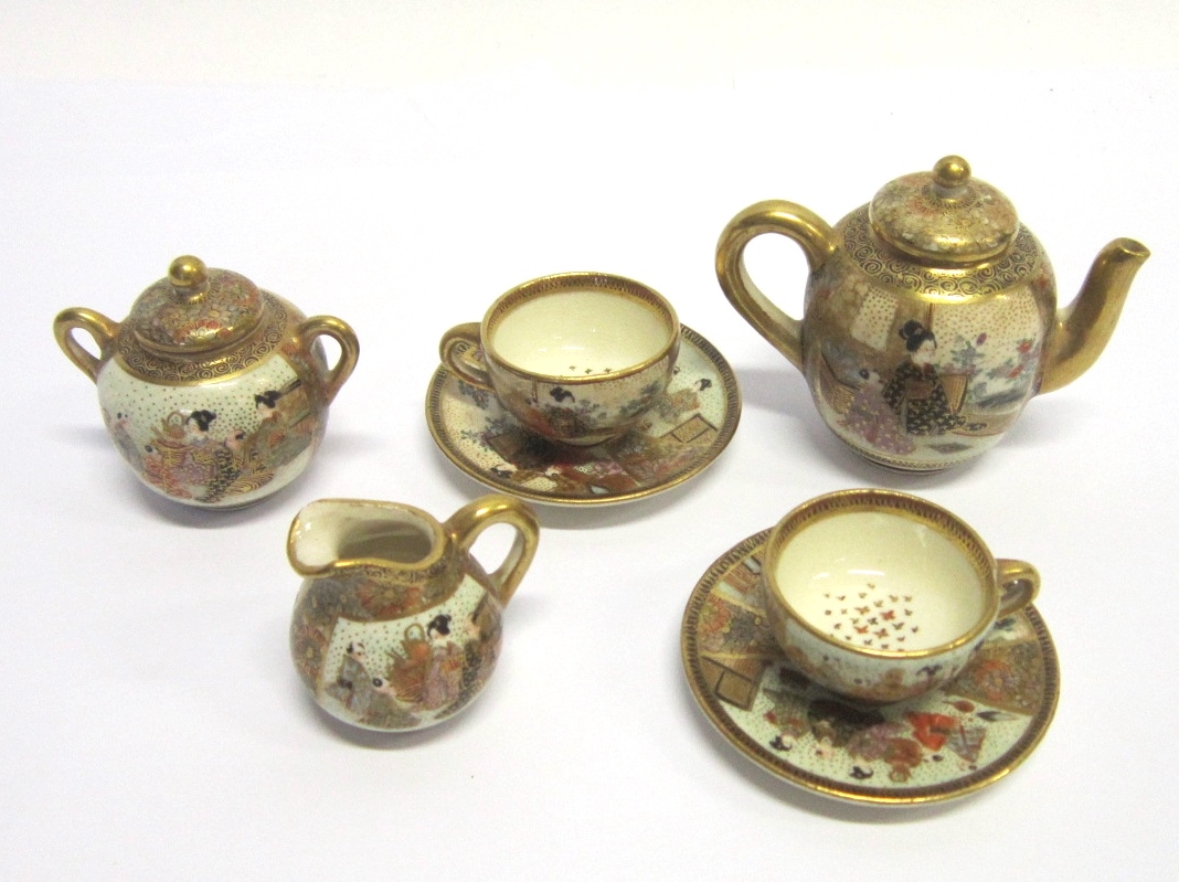 A JAPANESE SATSUMA MINIATURE TEA SERVICE comprising teapot, sucrier, milk jug, two cups and two