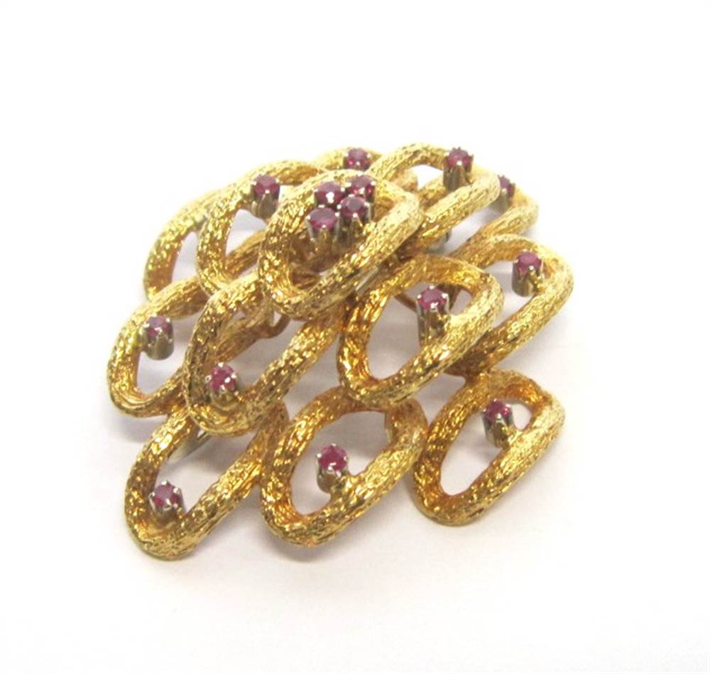 AN 18CT GOLD RUBY SET BROOCH Edinburgh import mark for 1971, composed of textured open ovals, each