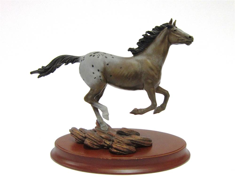 A `FRANKLIN MINT` CAST FIGURE OF AN APPALOOSA HORSE `Thunder on the Prairie` by Chuck DeHaan, on