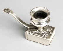 A go-to-bed candlestick decorated with a steeplechaser & jockey,
in white metal, the jumped in