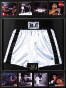 A pair of boxing trunks signed by Muhammad Ali, the white and black Everlast trunks signed in fine