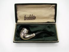 An Italian smoker's pipe by Brebbia featuring racehorses & jockeys,
the briarwood bowl mounted in