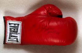 An Evander Holyfield signed boxing glove,
a left-hand red Everlast glove signed in black marker pen,