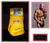 A Marvin Hagler signed boxing glove, a yellow Reyes signed in black marker pen Marvelous Marvin