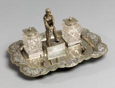 A silver plated cricket inkstand with presentation inscription dated 1886,
mounted with a batsman