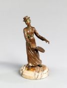A bronze of a lady tennis player circa 1880s,
modelled playing a backhand stroke, set on a