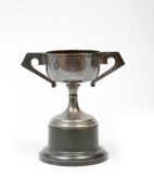 A silver greyhound trophy awarded at Wolverhampton in 1938,
an art deco cup with angular handles,
