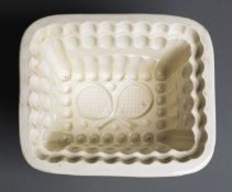 A Victorian pottery jelly mould by Copeland with tennis design,
racquets, balls, netting etc., cream
