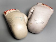 A pair of multi-signed boxing gloves,
a pair of white Lonsdale gloves, signatures including Muhammad