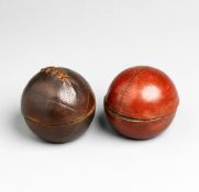 A pair of Edwardian inkpots modelled as a cricket ball and a football,
brass covered in red &