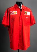 Michael Schumacher signed mid-2000s Ferrari team shirt by Fila,
his marker pen signature opposite