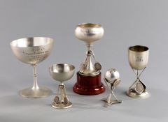 A group of four silver tennis trophy cups,
all hallmarked, one inscribed as a 1908 mixed doubles 1st