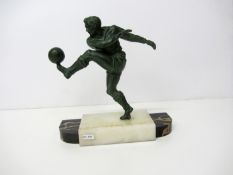 A spelter figure of a footballer,
green patina, modelled hitting a left foot volley, on stepped onyx