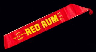 A Red Rum public appearance sash,
on a red satin ground with yellow lettering, inscribed both