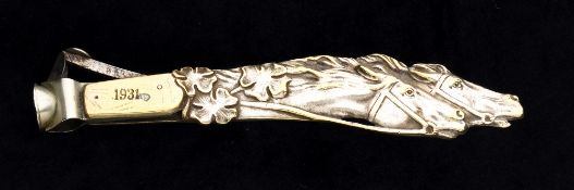 A cigar cutter inscribed "The Curragh" and dated 1931,
partly-gilded white metal, the handle