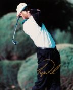 A Tiger Woods signed colour photograph,
a 10 by 8in. photo signed in gold marker pen, Woods