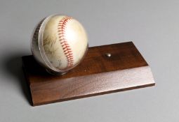 A baseball signed by the Yomiuri Giants including Sadaharu Oh,
in case and mounted on a wooden